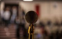 selective focus photography of brass-colored microphone
